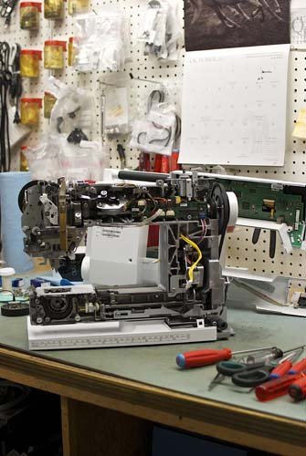Sewing machine technician servicing a machine