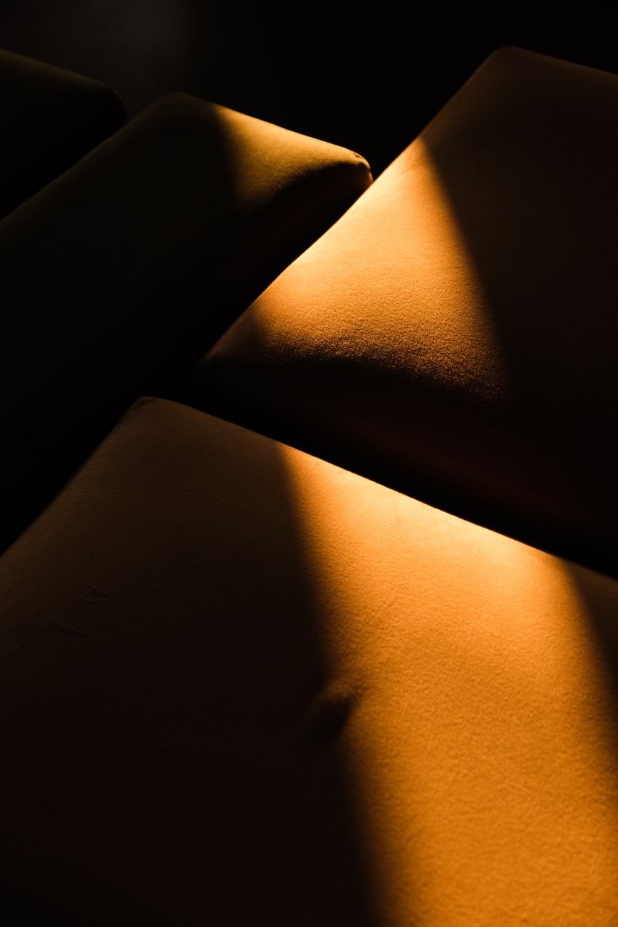 Soft sunlight casting shadows across suede cushions, showing texture and nap direction