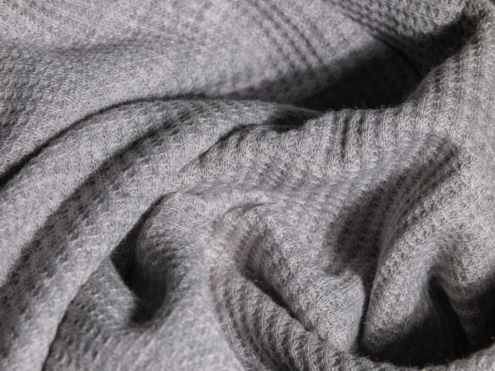 Close-up of grey waffle-knit thermal fabric texture