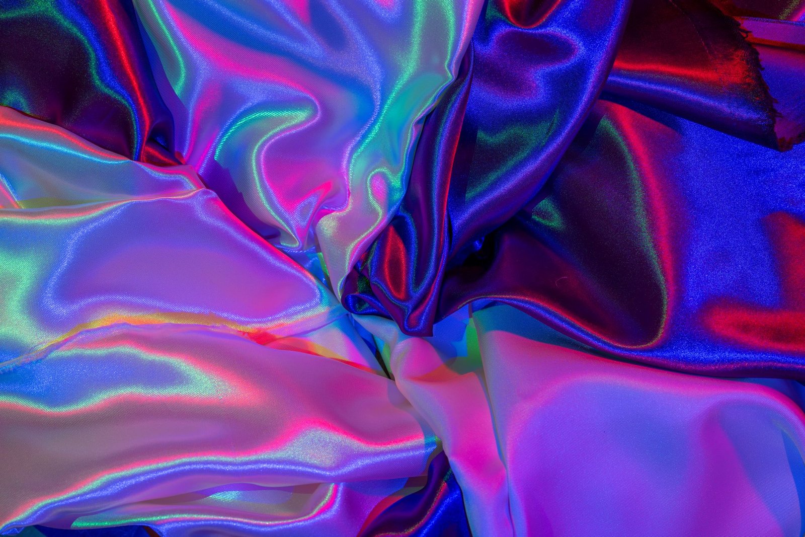 Iridescent fabric showing a rainbow color shift across its folds