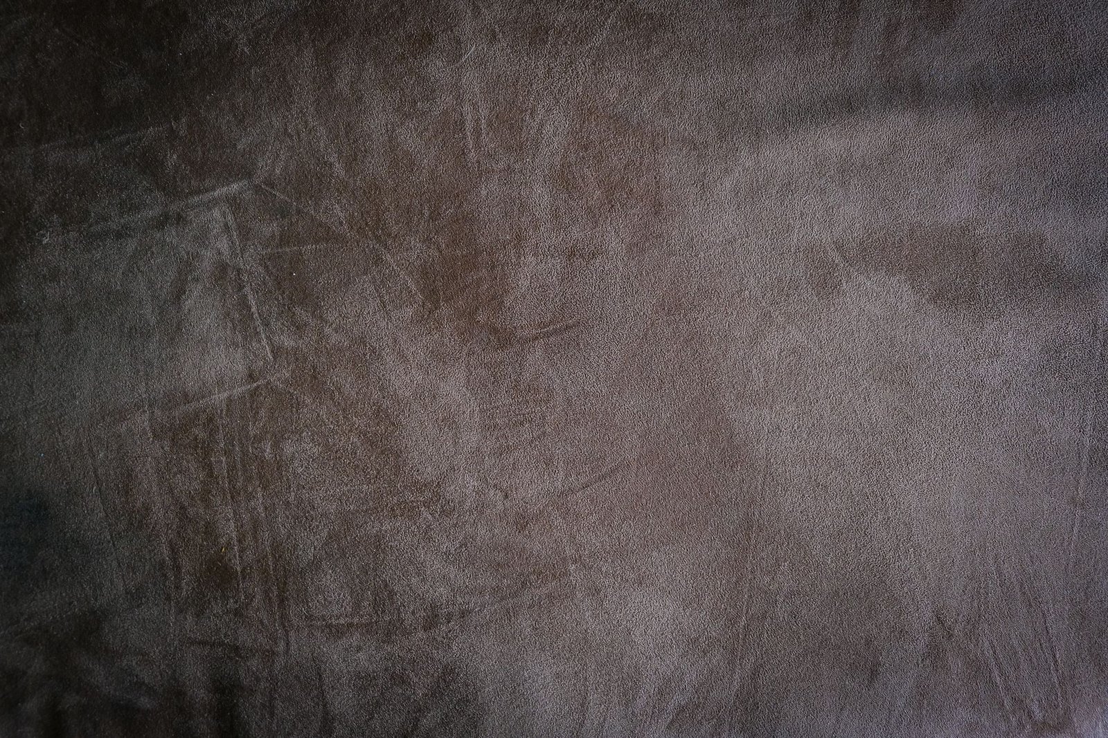 Close-up of brown suede-style fabric showing its rich, soft napped texture