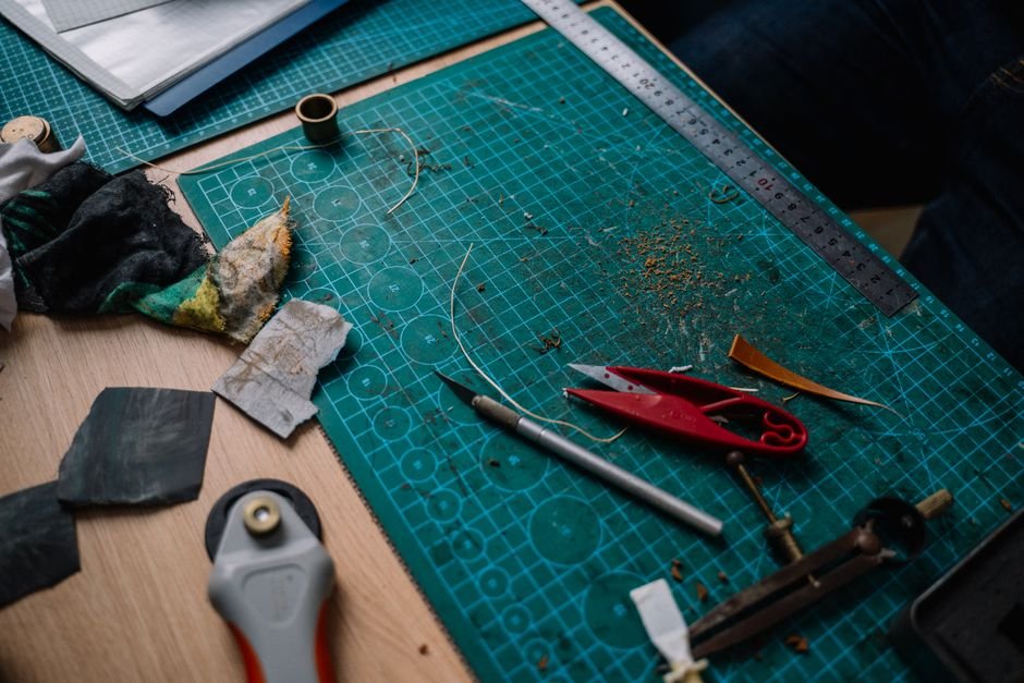 Geometric triangle ruler on a fabric cutting mat used for cutting 45 degree triangle shapes