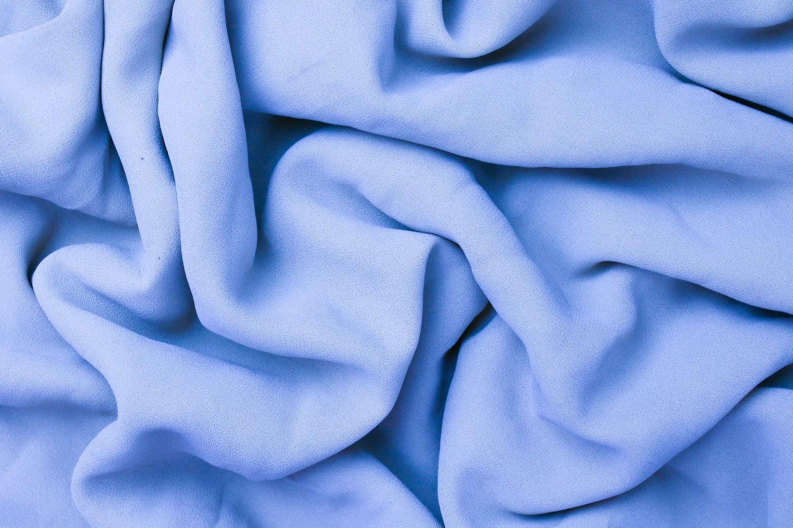 Soft light blue fabric folded in gentle drapes