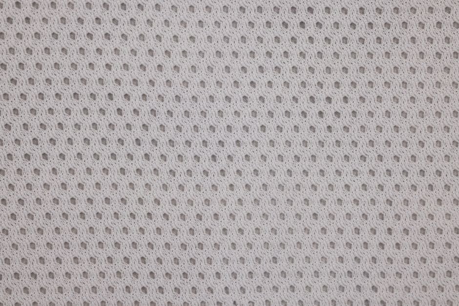 Close-up of finely woven fabric texture similar to the material used for cross stitch backing
