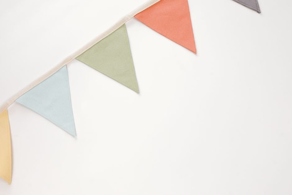 Colorful triangle pennant fabric bunting banner laid flat showing simple construction