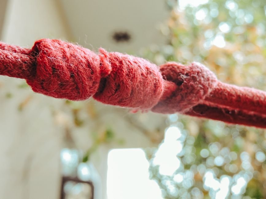 Red cord tied in a series of knots