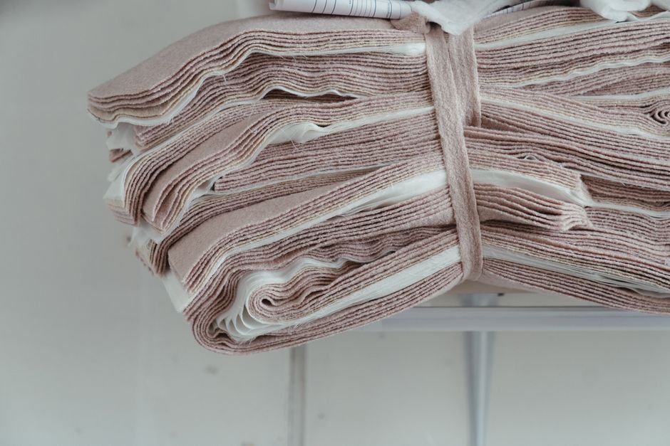 Folded white quilt batting roll ready to be cut for a twin size project
