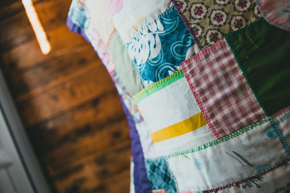 Close-up of a traditional patchwork quilt with zigzag stitched seams