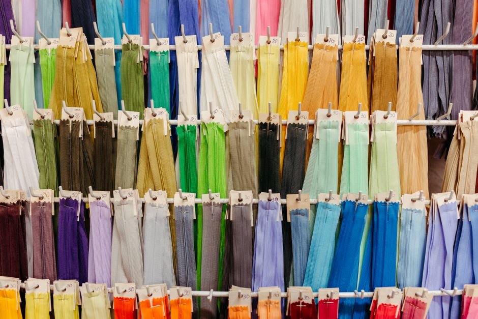 Colorful zipper pulls and sewing notions laid out together